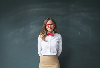Young woman in front of blackboard