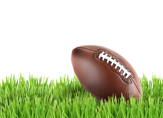 American football on green grass isolated on white