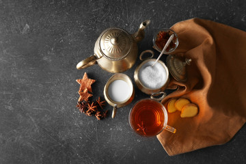 Ingredients for tea drinking on grey background, flat lay
