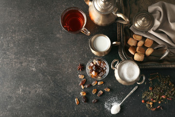 Ingredients for tea drinking on grey background, flat lay