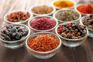 Various spices in glass bowls, close up
