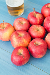 Ripe red apples with a glass of cider