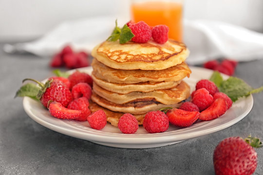 Tasty pancakes with berries on plate