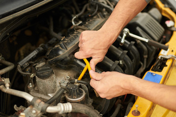 Mechanic use wrench for change spark plugs.