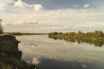 Autumn landscape with river on background sky