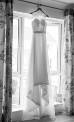 Wedding dress haning in a window