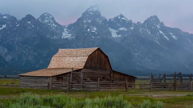 Iconic Mountains behind Barn with Clouds rolling by