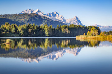Zugspitze mountain reflecting in the silent water of lake Gerold, Bavaria, Germany