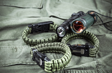 Military paracord bracelet, tactical torch and spy-glass - obrazy, fototapety, plakaty