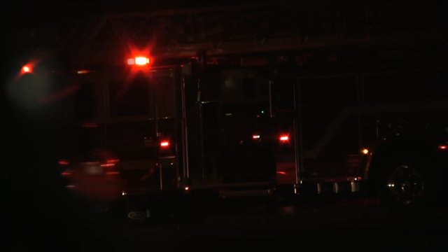 A parked fire trucks with lights flashing on the scene. HD 1080p.