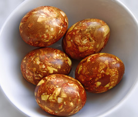 Close-up traditional hand made coloring easter eggs. Made with onion peel. Selective focus.