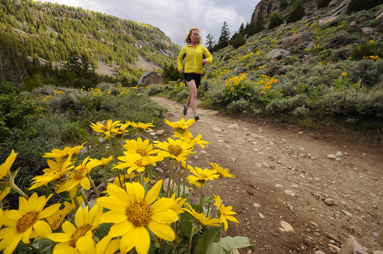 Woman trail running the Middle Fork Falls trail in Sinks Canyon, Lander, Wyoming. USA