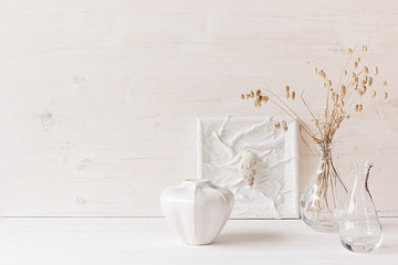 Soft home decor. Seashells and glass vase with spikelets   on  white wood background. Interior.