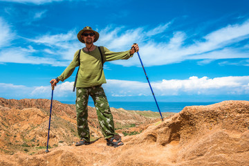 A man stands on top of the canyon Fairy Tale, Kyrgyzstan.