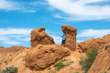 Fototapeta premium A woman among the beautiful cliffs of the canyon Fairy Tale, Kyr