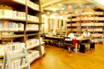 Student reading in modern library. Interior modern library for relax education in university. Soft focus and blurry effect.