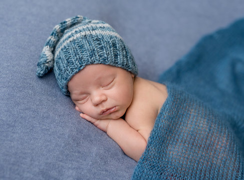 portrait of sweet sleeping newborn baby in hat