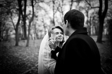 Black and white photo of gorgeous bride drinking champagne with