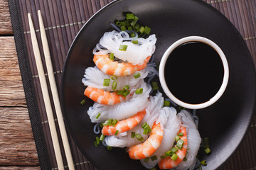 Shirataki Noodles with shrimp and green onions close-up. Horizontal top view
