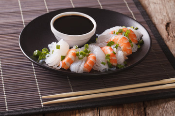 Japanese food: Shirataki with prawns, spring onions and soy sauce close-up. horizontal

