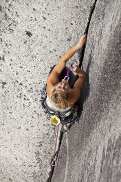 A strong female climber climbing Crescent Crack 10d, Squamish, BC