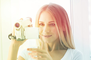woman holds a home video camera