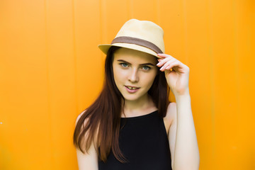 Smiling summer woman with hat and sunglasses over bright background.