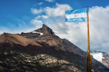 Argentine flag flying in front of the mountain Cerro Moreno in Los Glaciares National Park,...