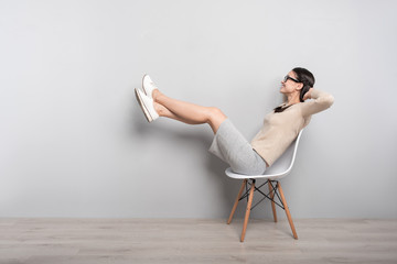 Joyful woman resting in the chair