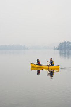 Young/middle-aged man going fishing with son on Source Lake, Algonquin Provincial Park, Ontario, Canada.