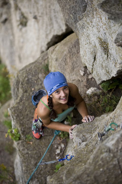 Teenage girl rock climbing, Rattle Snake Point, Ontario, Canada