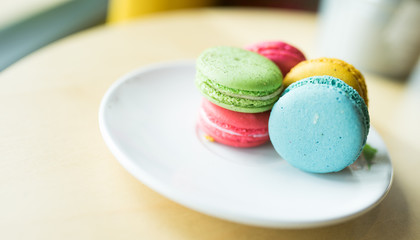 French colorful macarons background,Colorful macarons on vintage pastel background. Macaron or Macaroon is sweet meringue-based confection.