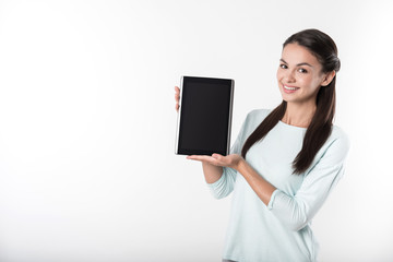 Cheerful woman holding tablet