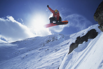 A snowboarder catching air at Lake Louise Resort, Alberta, Canada.