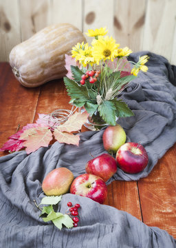 Autumn apples and pumpkins on wooden table