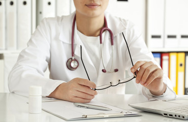 Woman doctor writing prescription