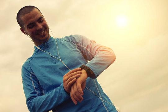 Joyful Runner Looking At Smart Watch. Focus On Face