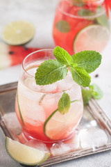 Fresh watermelon lemonade with lime, ice and mint for the summer party on the metal tray