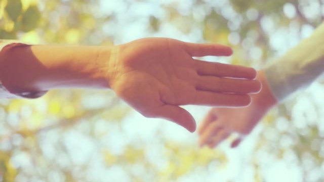 Many hands together over sky and trees in slowmotion. 1920x1080