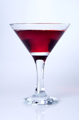 Martini glass  with color drink close-up, decoration on the edge of a white crumb