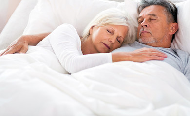 Senior couple sleeping in bed
 - Powered by Adobe
