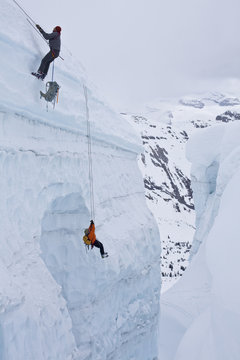 Two men practice crevasse rescue skills while on a ski mountaineering course, Ice fall Lodge, Golden, British Columbia, Canada