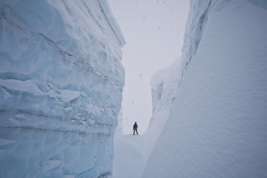 A male backcountry skier explores a large crevasse in the canadian rockies near golden, British Columbia, Canada, Icefall Lodge