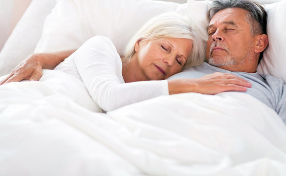 Senior couple sleeping in bed
