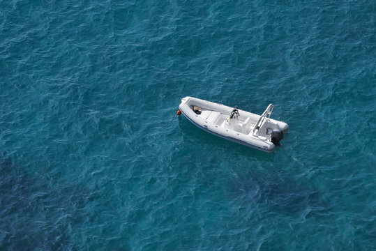 Aerial view of a white speed boat on a blue clear sea water