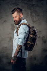 Fototapeta na wymiar Portrait of bearded traveller male with tattooed arms.