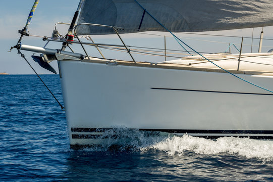 Close view at sailboat bow with hoisted genoa is sailing in the Mediterranean