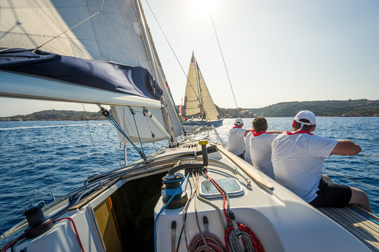 Fototapeta Sailboat bow with hoisted headsail and copy space on the boat hull.