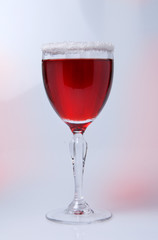 Wine glass close-up, decoration on the edge of a white crumb