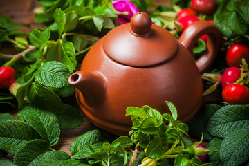 Obraz na płótnie Canvas Healthy tea with a dogrose on wooden table